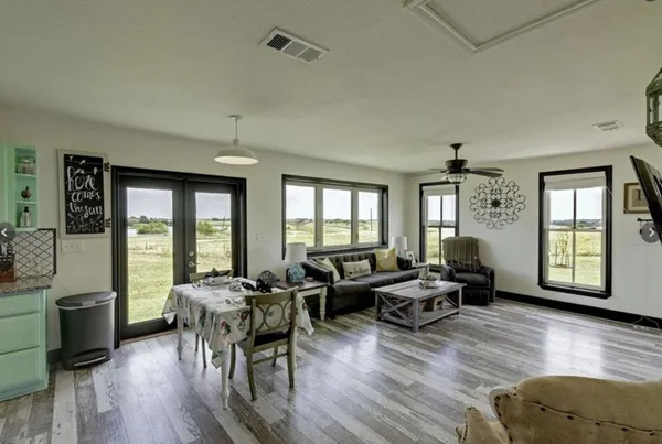 a living room with furniture and wooden floor