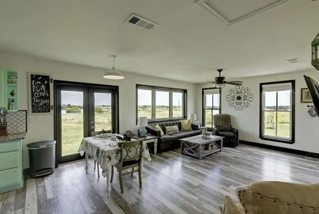 a living room with furniture and wooden floor
