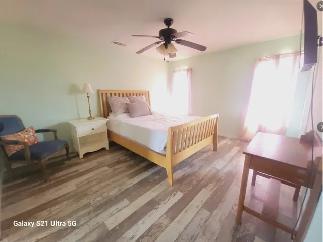a bedroom with bed and a chandelier