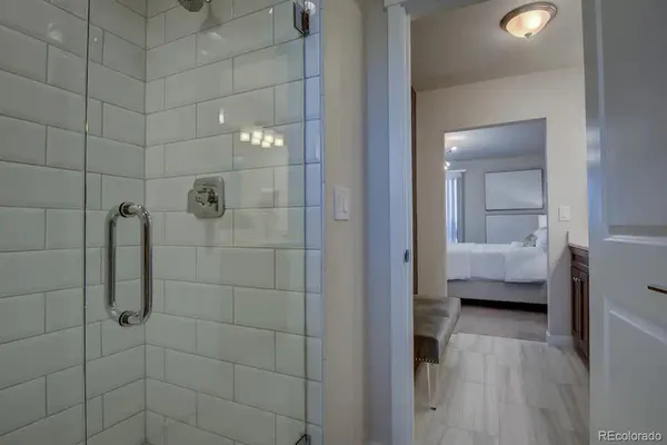 a bathroom with a toilet and a glass door shower
