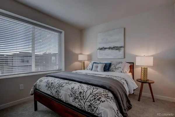 a bedroom with a bed and a night stand