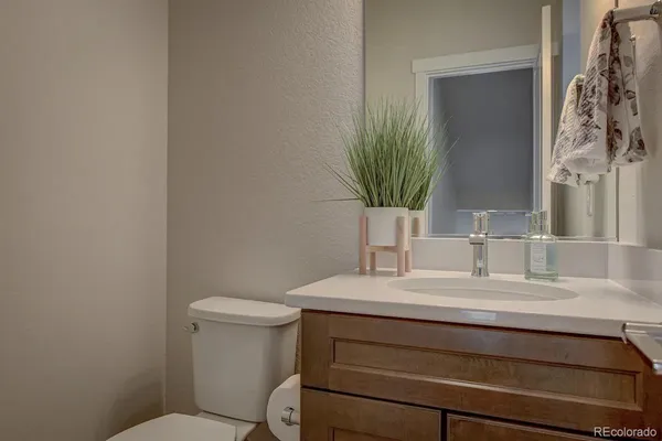 a bathroom with a sink toilet and mirror