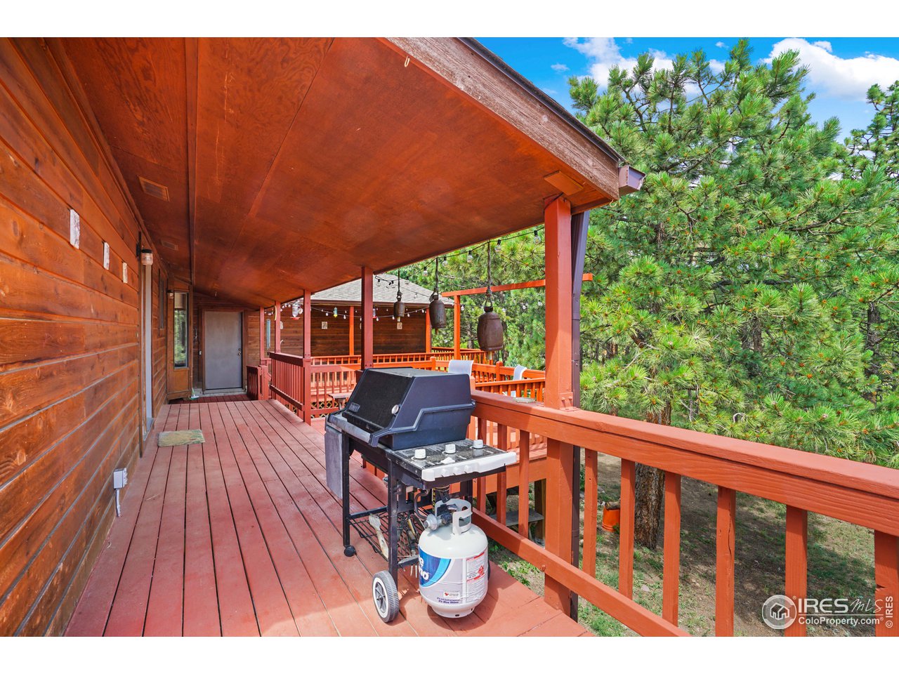4147 Sugarloaf Road Boulder, CO 80302 - Photo 29 of 38 a balcony with wooden floor and outdoor seating