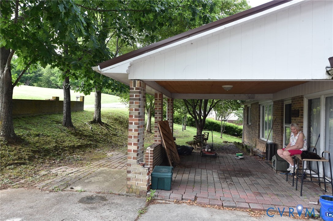 642 Star Street Pounding Mill, VA 24637 - Photo 2 of 20 Covered patio featuring brick pillars and a wood-f