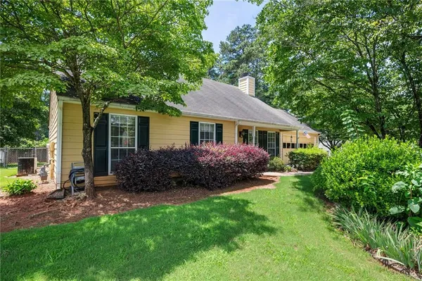 a front view of a house with a garden and porch