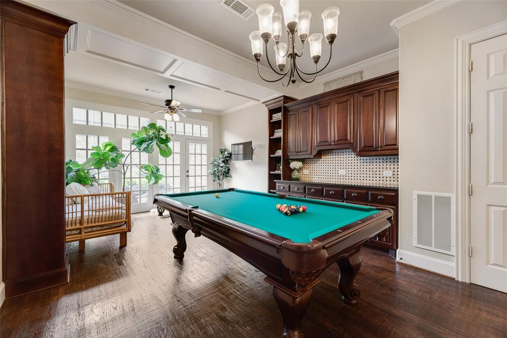 1909 Rising Star Drive Allen, TX 75013 - Photo 16 of 26 Rec room featuring ceiling fan, dark wood-style flooring, french doors, ornamental molding, and pool table