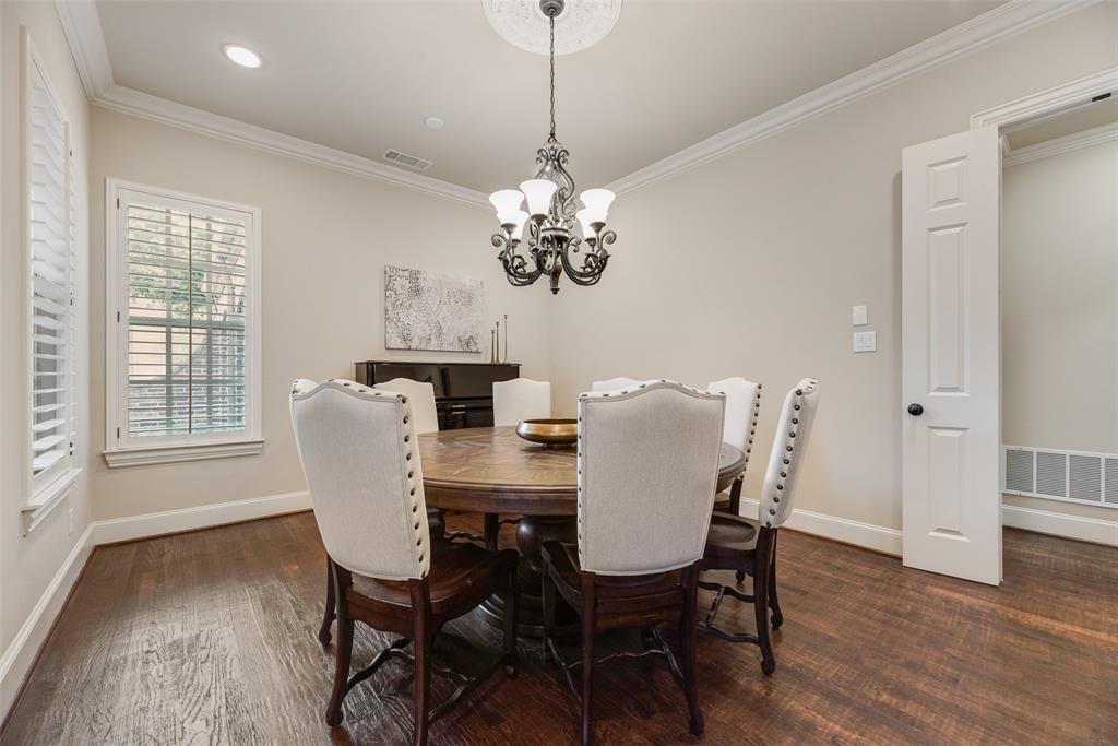 1909 Rising Star Drive Allen, TX 75013 - Photo 4 of 26 Dining space with dark wood-style flooring, ornamental molding, and suspended lighting
