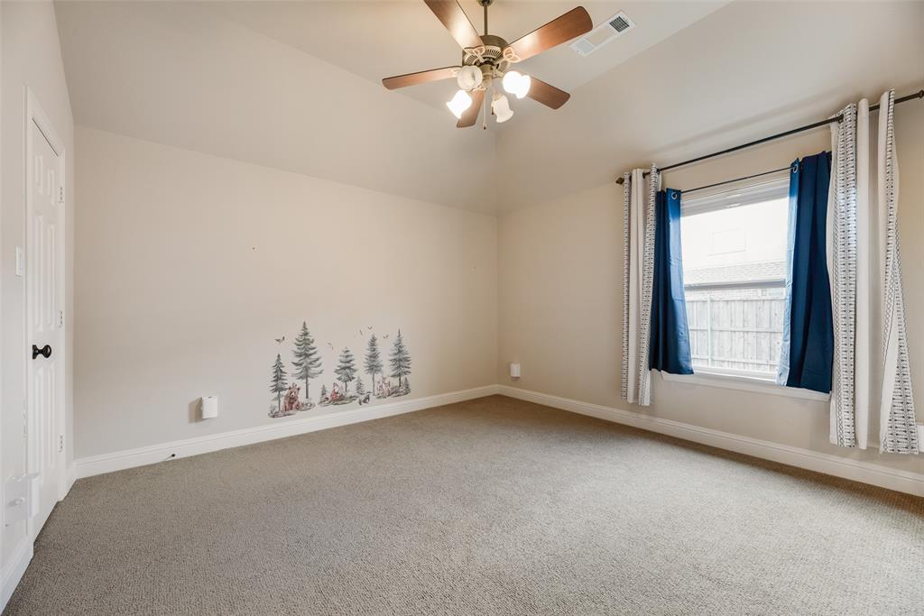 1909 Rising Star Drive Allen, TX 75013 - Photo 8 of 26 Carpeted spare room with vaulted ceiling and a ceiling fan