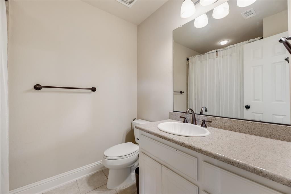 1909 Rising Star Drive Allen, TX 75013 - Photo 9 of 26 Bathroom featuring vanity, light tile patterned floors, and curtained shower