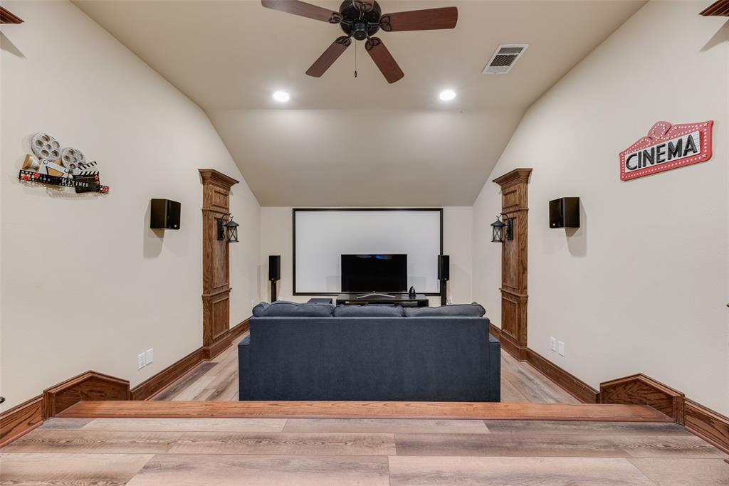 1909 Rising Star Drive Allen, TX 75013 - Photo 10 of 26 Home theater with ceiling fan, light wood-type flooring, recessed lighting, and vaulted ceiling