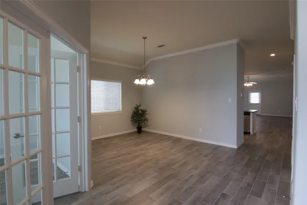 a view of a room with wooden floor and window
