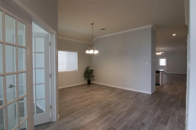 a view of a room with wooden floor and window