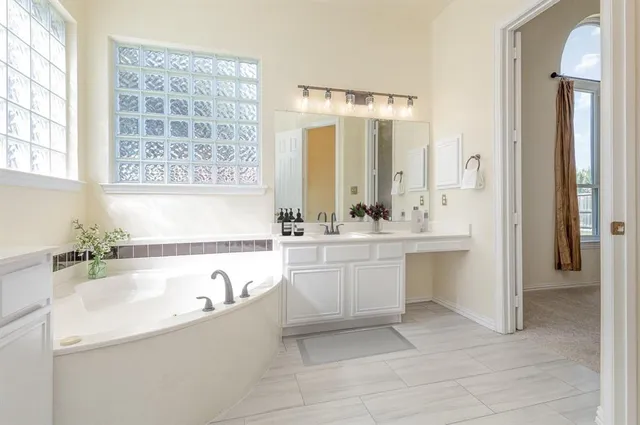 a spacious bedroom with a bed and glass window
