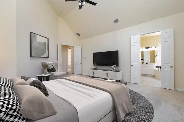 a bedroom with a bed and a painting on the wall