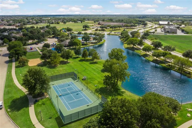 an aerial view of residential houses with outdoor space and swimming pool