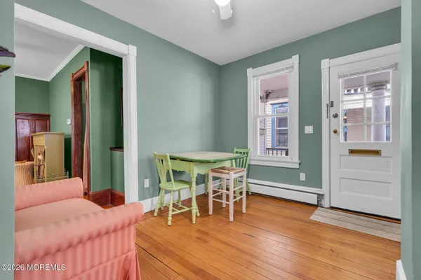 a living room with furniture and a wooden floor