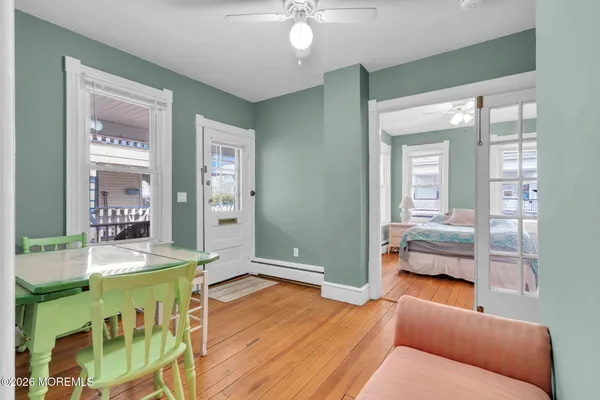 a bedroom with furniture and a wooden floor