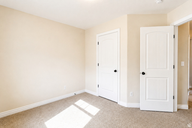 896 Cres Drive South Mapleton, UT 84664 - Photo 21 of 32 Neutral-toned wall finish with white trim, two panel doors with black hardware, and carpet flooring