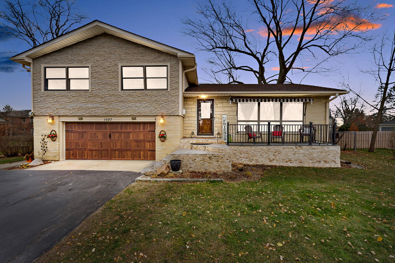 1527 Sunset Ridge Road Glenview, IL 60025 - Photo 1 of 20 a front view of a house with a yard and garage