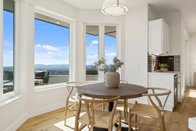 a living room with furniture and kitchen view