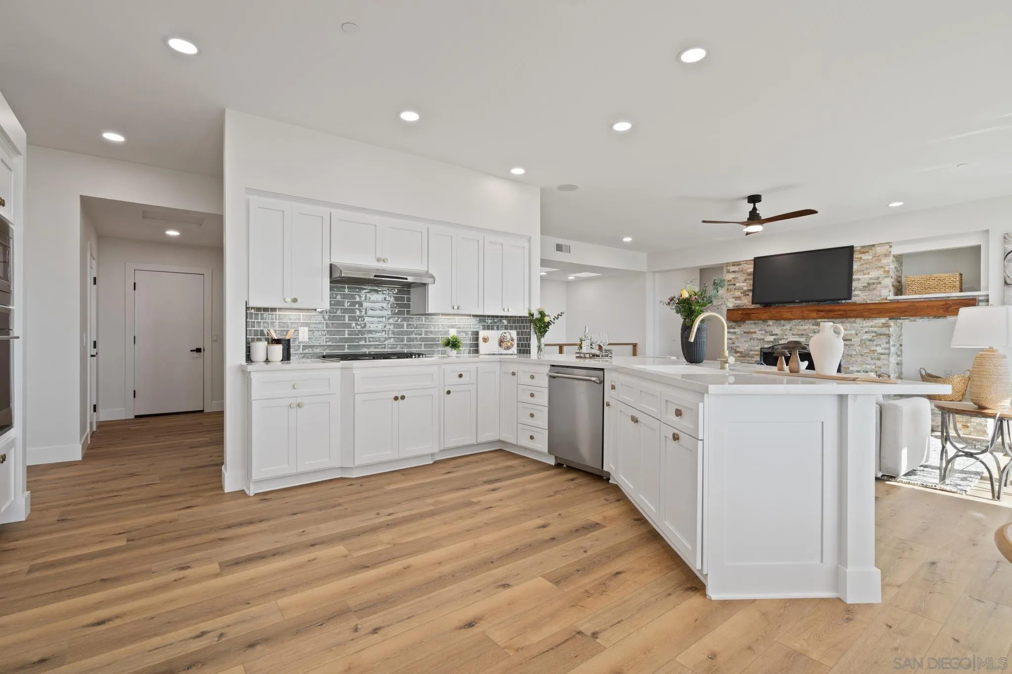 15486 Markar Road Poway, CA 92064 - Photo 13 of 63 a kitchen with white cabinets and stainless steel appliances