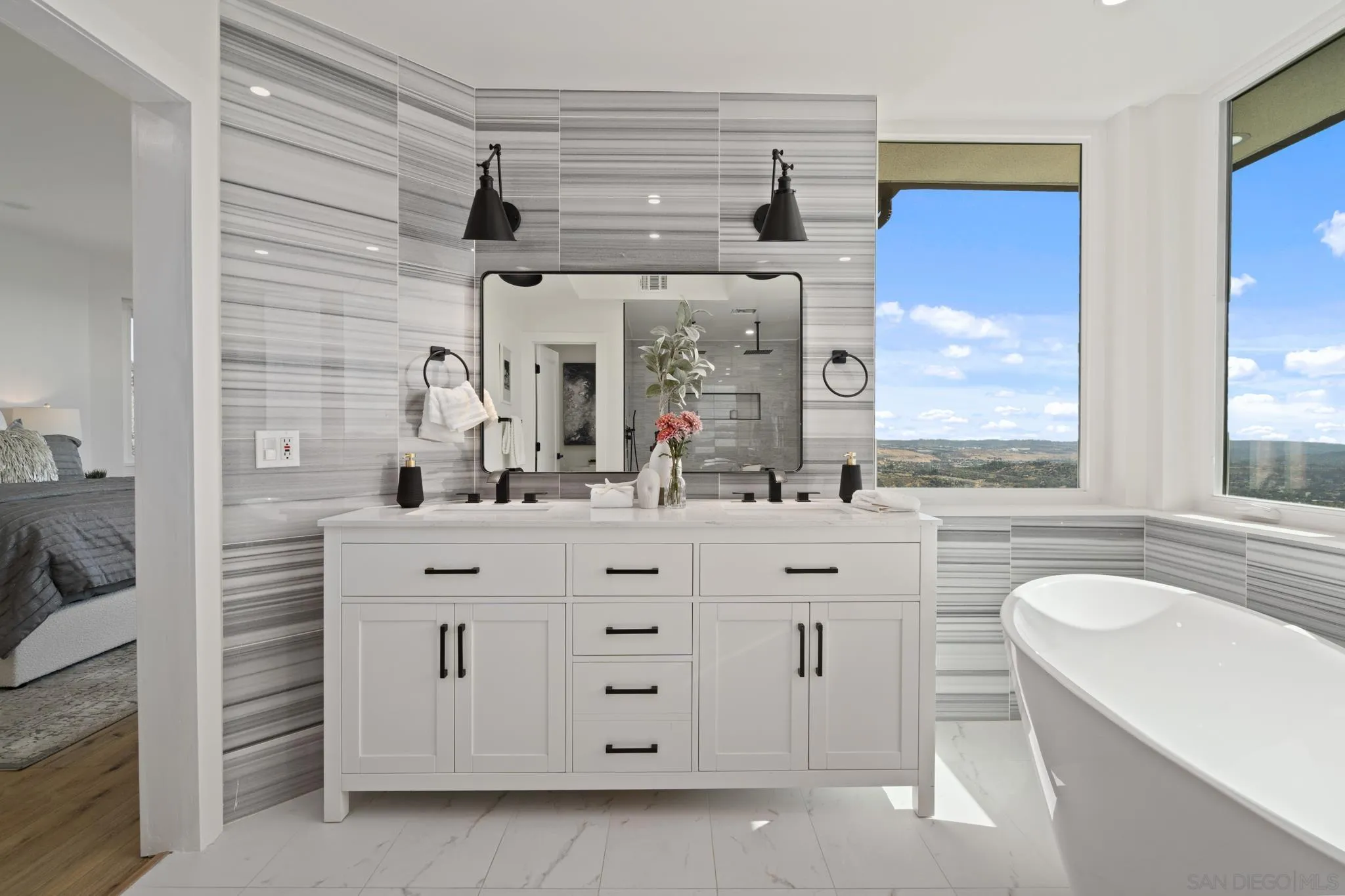 15486 Markar Road Poway, CA 92064 - Photo 22 of 63 a bathroom with a granite countertop sink a mirror a vanity and a bathtub