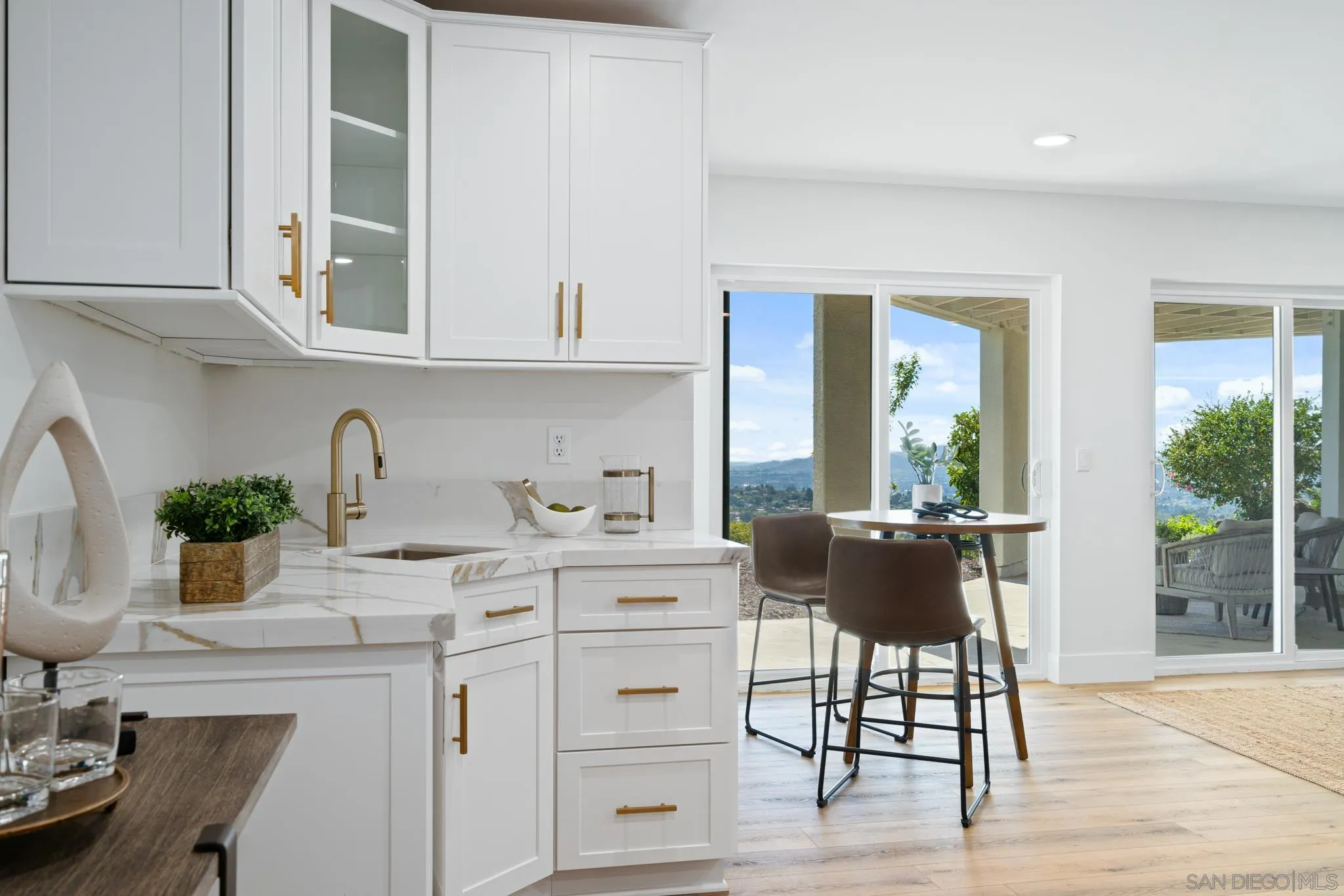 15486 Markar Road Poway, CA 92064 - Photo 35 of 63 a kitchen with granite countertop a table chairs stove and cabinets