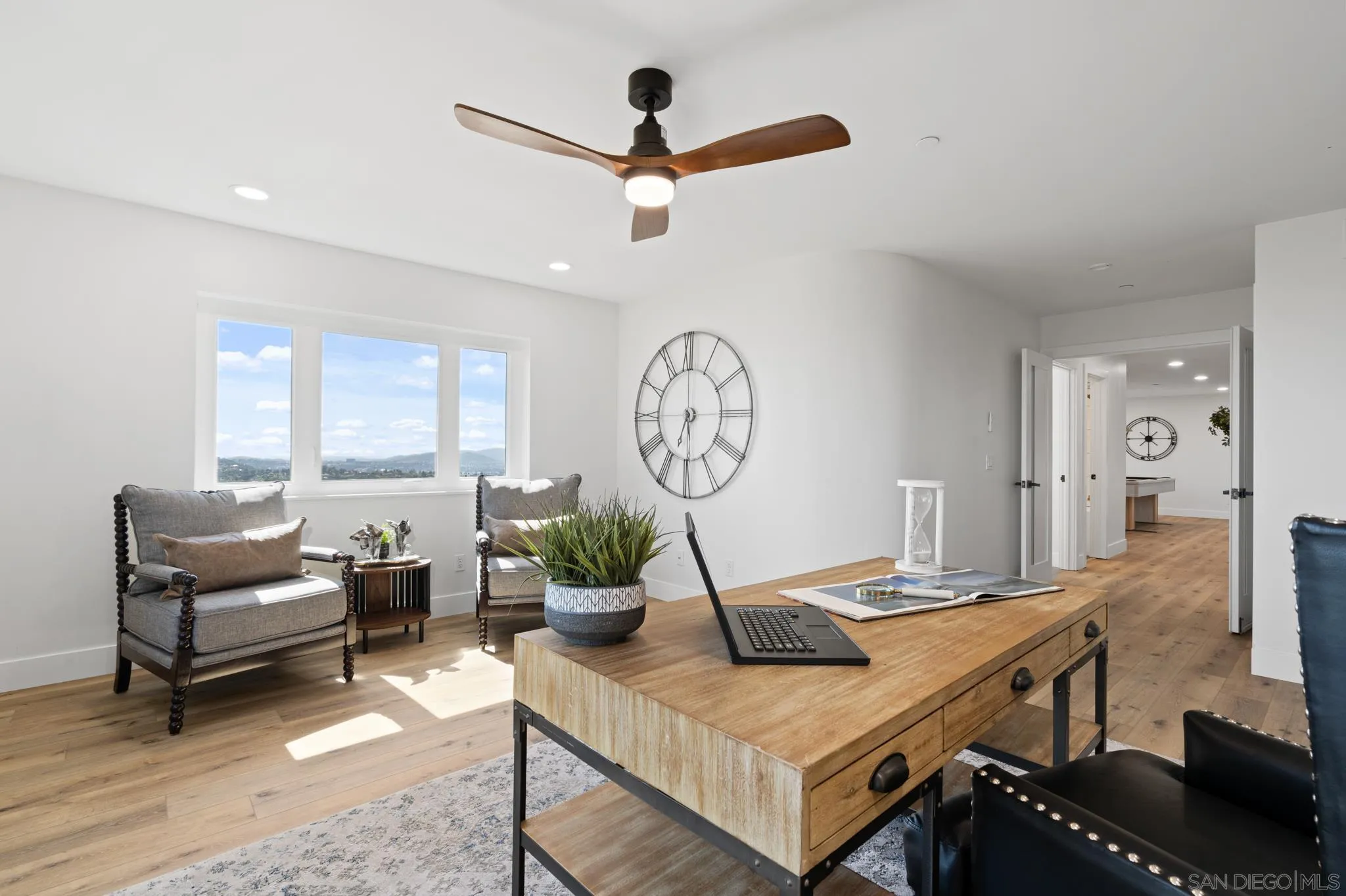 15486 Markar Road Poway, CA 92064 - Photo 40 of 63 a living room with furniture a window and a clock