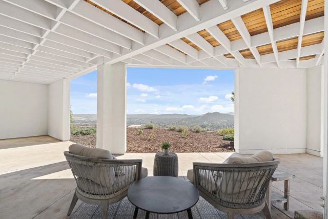 an aerial view of a house with a yard and sitting area
