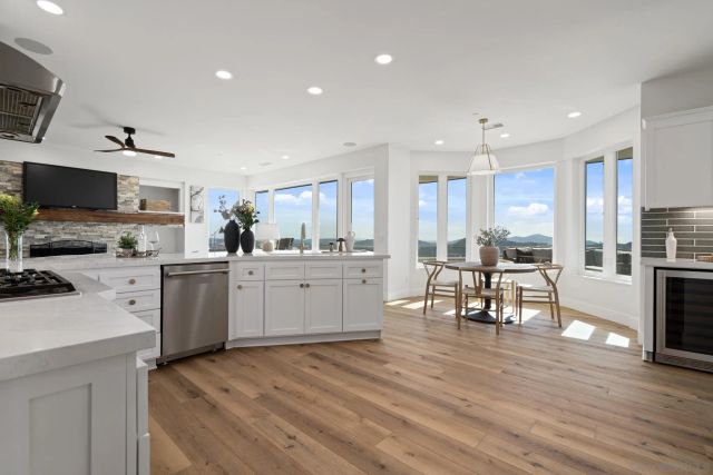 a living room with furniture and kitchen view