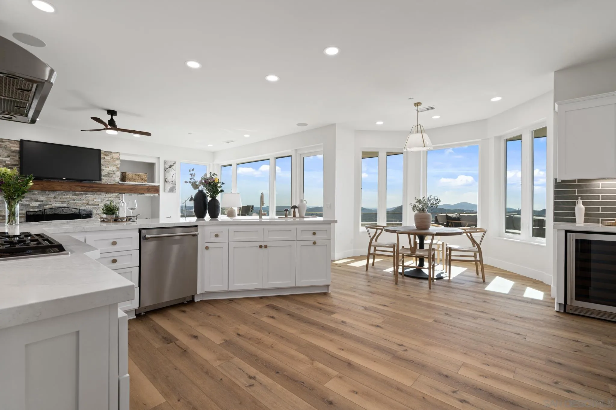15486 Markar Road Poway, CA 92064 - Photo 9 of 63 a kitchen with white cabinets and stainless steel appliances