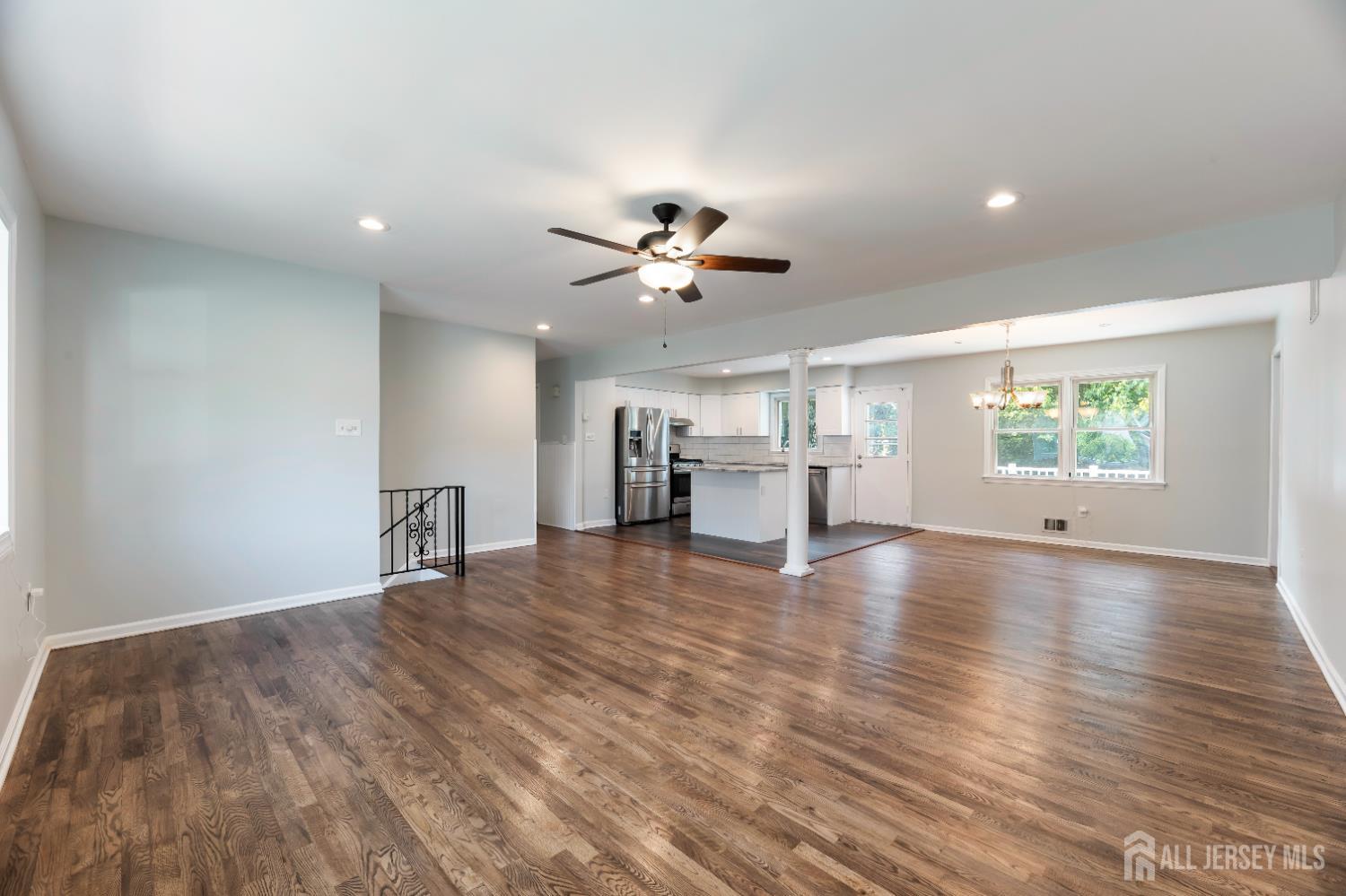 5 Estok Road Edison, NJ 08817 - Photo 5 of 40 a view of an empty room with chandelier fan and wooden floor