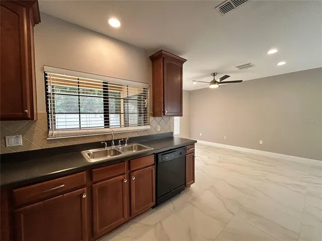 a kitchen with a sink and large window