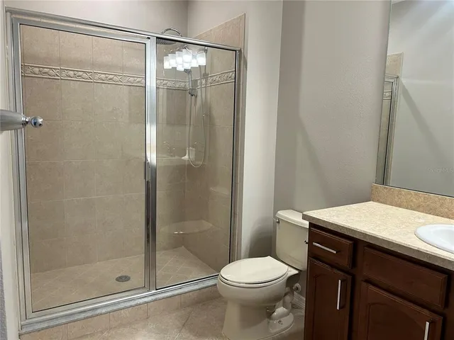 a bathroom with a shower a toilet and a sink