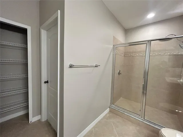 a bathroom with a glass shower door