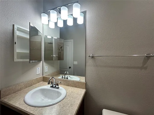 a bathroom with a sink and a mirror
