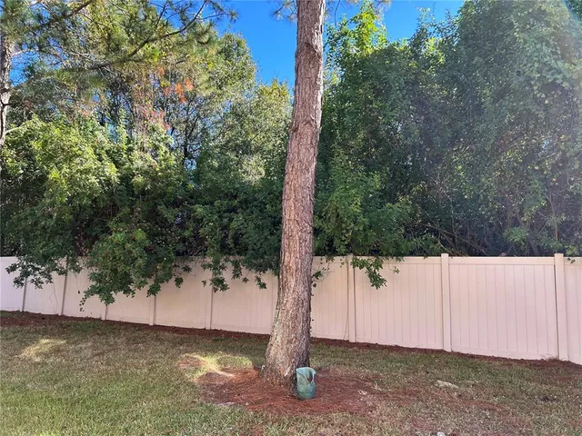 a view of a patio with table and chairs and potted plants