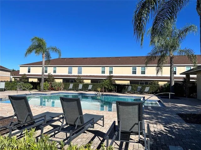 a swimming pool with outdoor seating and yard