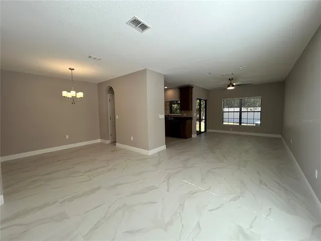 an empty room with a empty space and windows