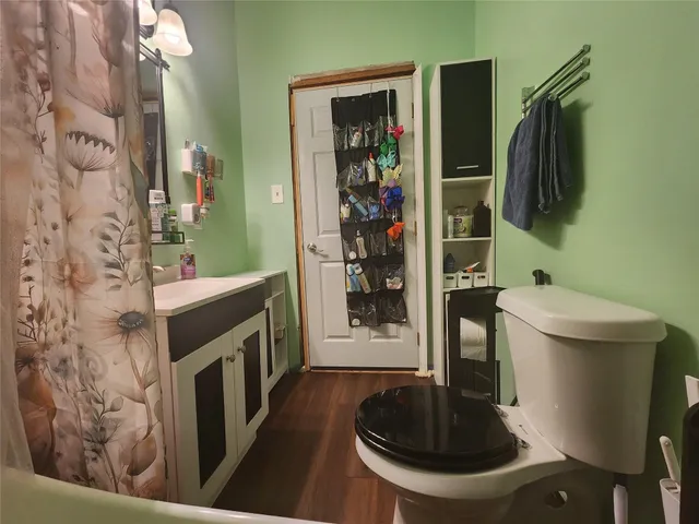 a bedroom with a bed dresser and mirror