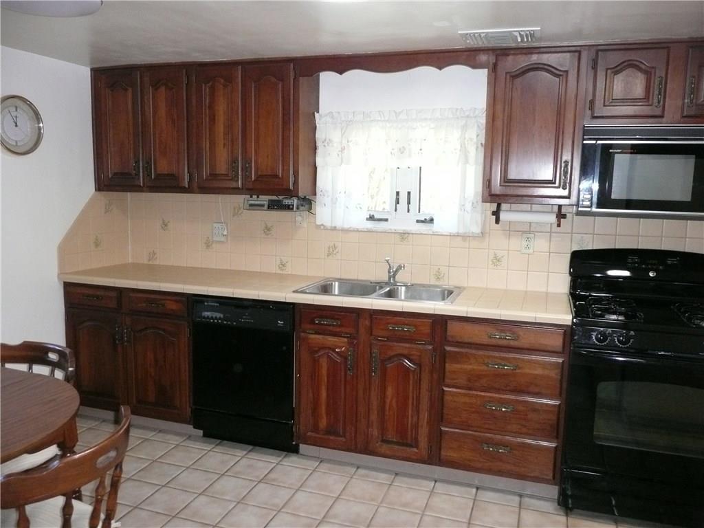 70 McMichael Road Carnegie, PA 15106 - Photo 8 of 21 LARGE EAT-IN KITCHEN WITH WOOD CABINETS, CERAMIC FLOOR, COUNTER TOPS, AND TUBE SKYLIGHTS