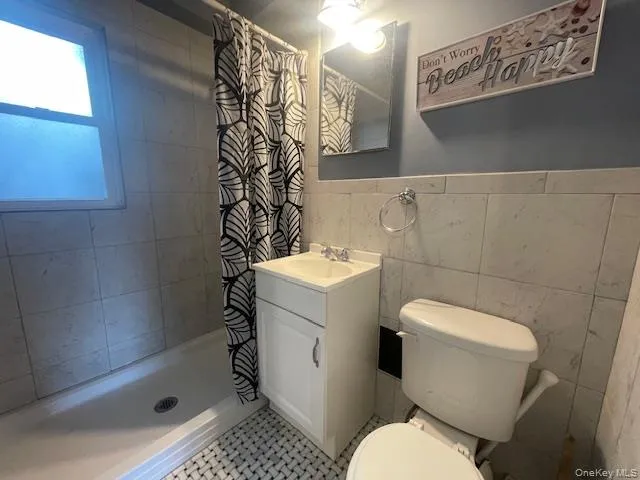 a white toilet sitting next to a bathroom sink