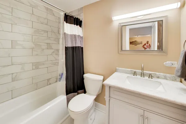 a bathroom with a toilet a sink and bathtub