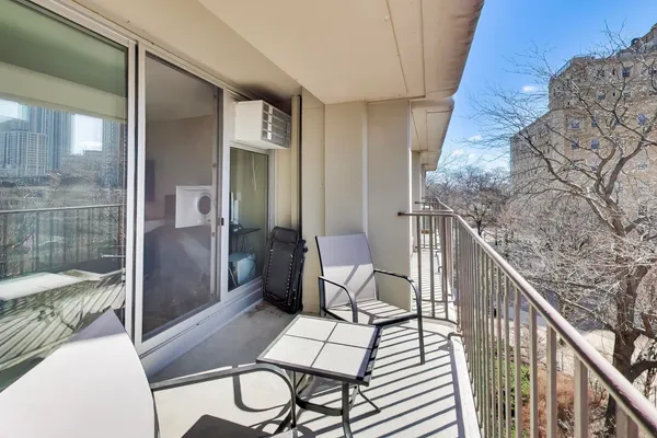 a balcony view with a seating space