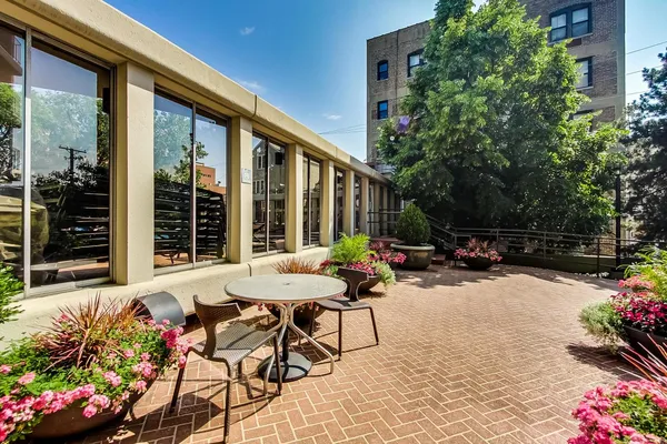 a view of a tables and chairs in back yard of the house