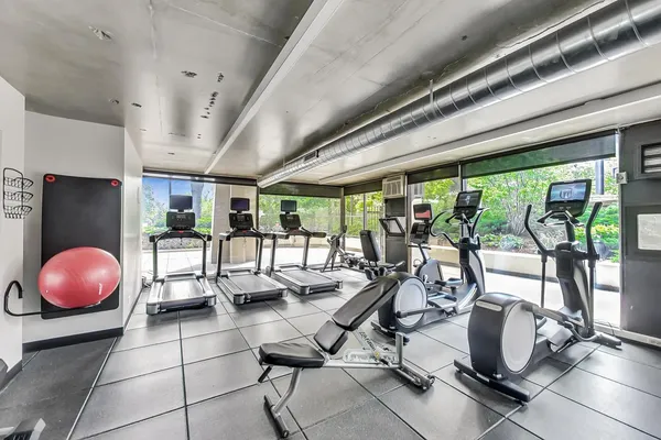 a room with gym equipment and floor to ceiling window