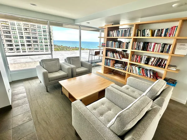a living room with furniture and a book shelf