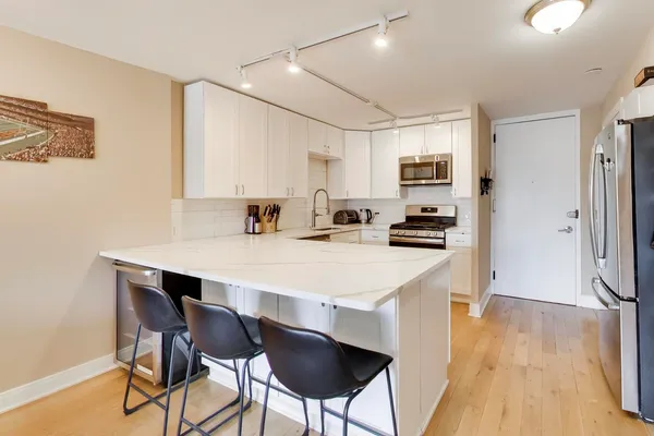 a kitchen with a table chairs refrigerator and cabinets