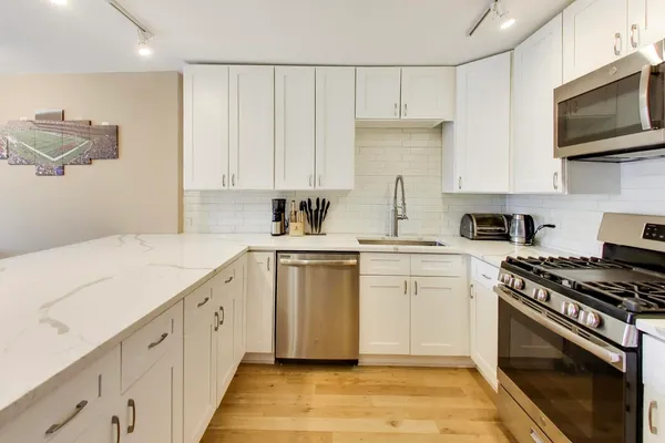 a kitchen with appliances cabinets and a sink
