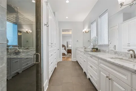 a large bathroom with a double vanity sink and a mirror